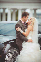 Bride and groom at wedding day kissing at park