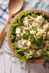egg salad in wooden bowl, close-up, rustic. vertical top view
