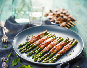 Grilled green asparagus wrapped in bacon
