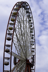 Ferris wheel on the  sky with clouds background. Ukraine. Kharki