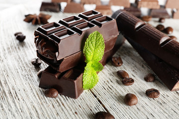 Stuffed chocolate with coffee beans on wooden table, closeup