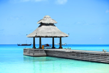 Boardwalk to arbor over blue ocean in Baros Maldives
