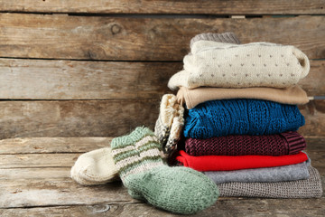 Fototapeta na wymiar Knitting clothes on wooden background
