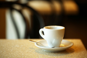 Cup of coffee on table in cafe