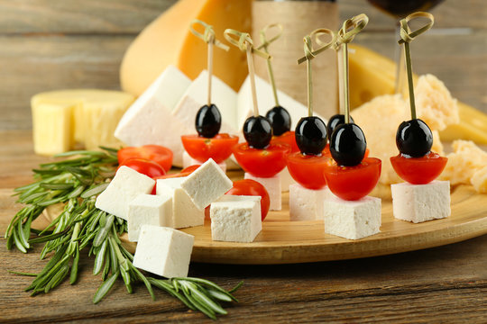 Cheese canapes with with rosemary on table close up