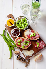 Italian snacks. salami sandwich with parmesan cheese & broad bea