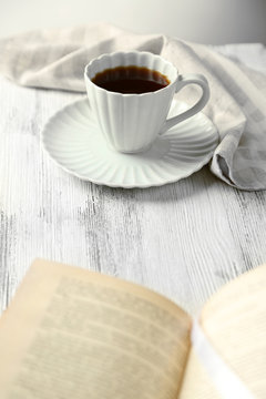 Still life with cup of coffee and book, close up