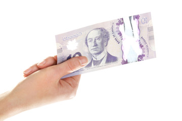Female hand with Canadian 10 Dollar, isolated on white