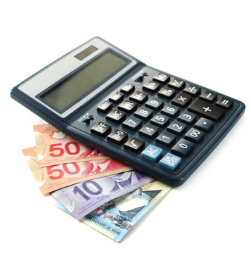 Calculator and Canadian dollars, isolated on white