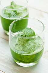 green smoothies on a brown background