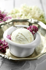 Beautiful composition with tasty ice cream and lilac flowers