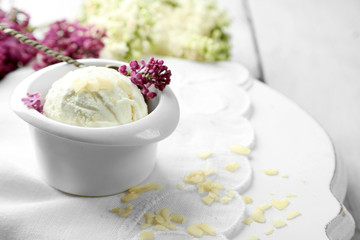 Beautiful composition with tasty ice cream and lilac flowers