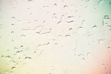 Drops of rain on blue glass background / drops on glass