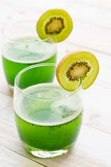 kiwi smoothie in glass on a old white wooden background