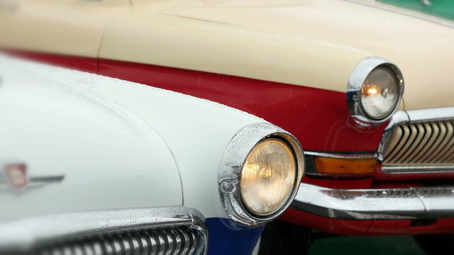Old-fashioned cars in the rain.