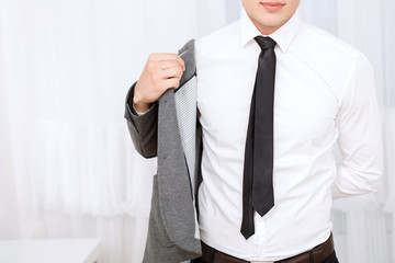 Close up of man putting on jacket.