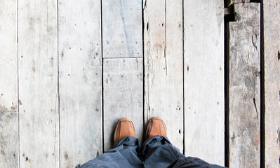 aerial view of people looking down to see wood floor