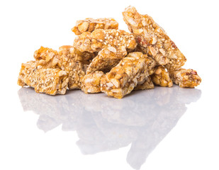 Caramelized candy nuts over white background 