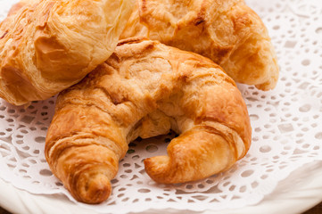 fresh croissants on wooden table