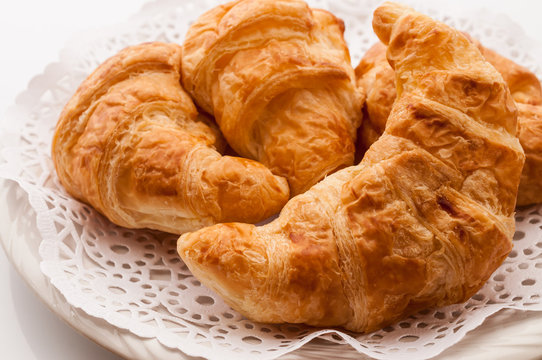 fresh croissants on wooden table