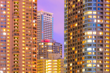Fototapeta na wymiar Facades of high-rise buildings at night