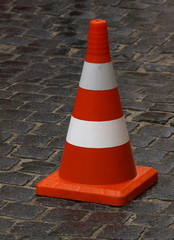 road cone standing on wet pavement