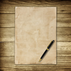 old brown paper and pen on wooden wall background for texture