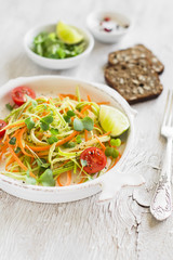 fresh salad with zucchini and carrots in a vintage plate 