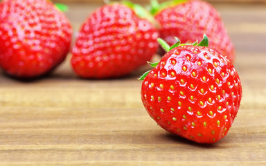 Ripe strawberries on wooden table. Fresh strawberries on wooden