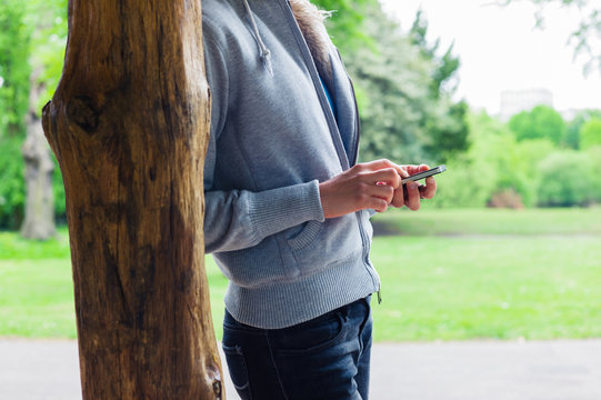 Woman using her smartphone in the park