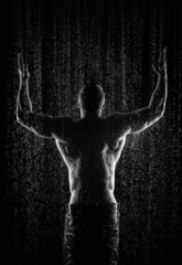 Fototapeta na wymiar very muscular handsome athletic man in the rain
