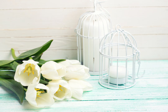 Background with  white tulips and candles.