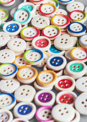 Obraz premium Multi colored buttons wooden background
