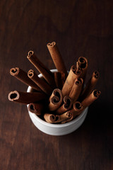 cinnamon on a white plate and a wooden background