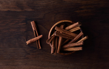 cinnamon on a wooden plate and background