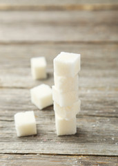 Sugar cube on grey wooden background