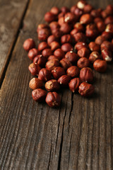 Hazelnuts on brown wooden background