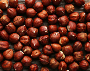 Hazelnuts on brown wooden background