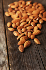 Almonds on brown wooden background