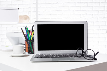 Office open laptop with blank screen