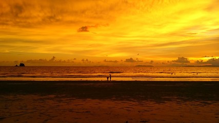 Naklejka na ściany i meble beach with shading sky background at sunset moment