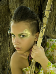 Amazon Girl with creative body-art and face-art with spear