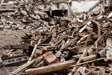 A closeup image of a garbage dump with ruined brick and wooden 