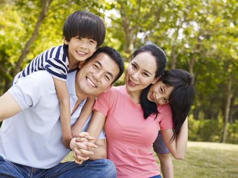 outdoor portrait of a happy asian family