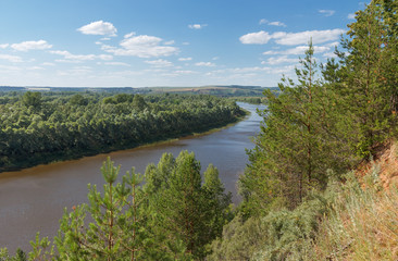 Summer landscape with a river from a high bank 
