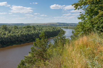 Summer landscape with a river from a high bank