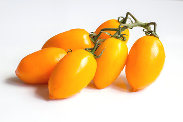 Cluster yellow tomato on light wooden texture