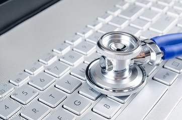 Diagnosis and repair of computers. Stethoscope on laptop