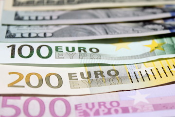 Background of euro and dollar bills. Shallow focus.