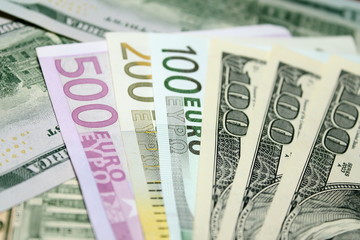 Background of euro and dollar bills. Shallow focus.